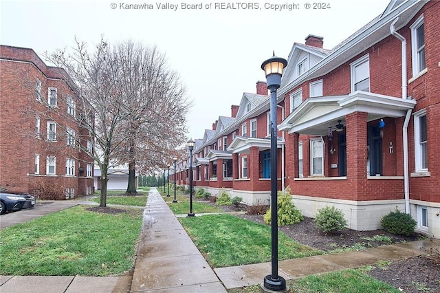 view of street featuring a residential view, street lights, and sidewalks