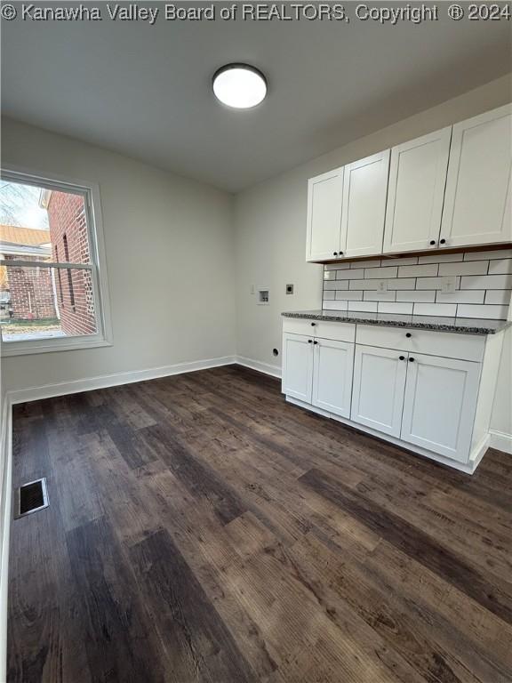 washroom featuring cabinets, hookup for a washing machine, and dark hardwood / wood-style floors