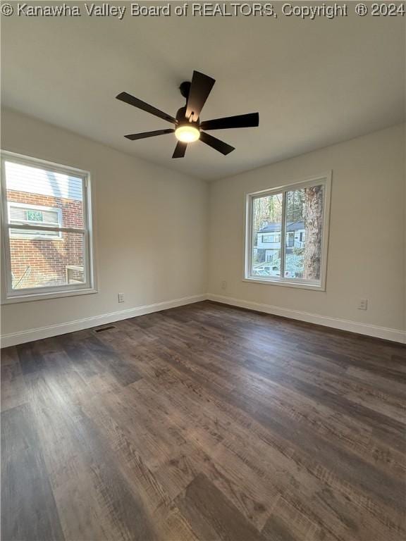 unfurnished room with dark hardwood / wood-style floors and ceiling fan