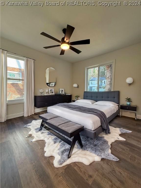 bedroom with dark hardwood / wood-style floors, multiple windows, and ceiling fan