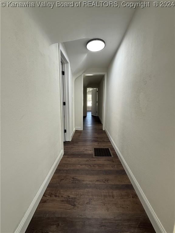 corridor featuring dark hardwood / wood-style floors