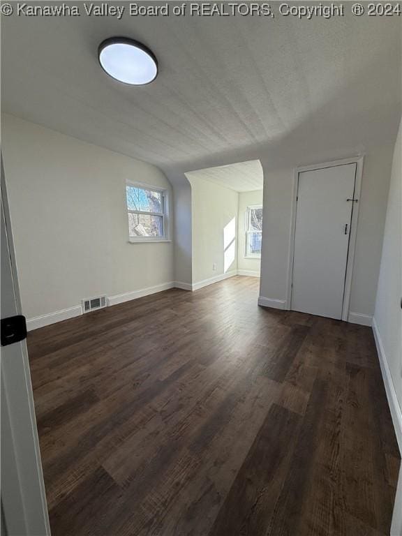 bonus room with dark hardwood / wood-style floors