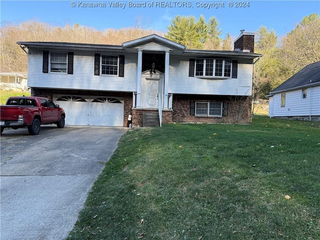 split foyer home with a front yard and a garage