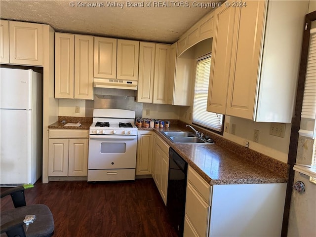 kitchen with white appliances, sink, and dark wood-type flooring