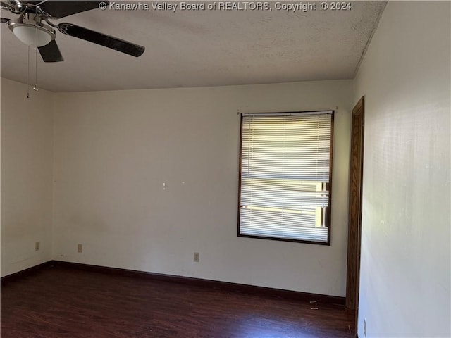 unfurnished room featuring ceiling fan and dark hardwood / wood-style floors