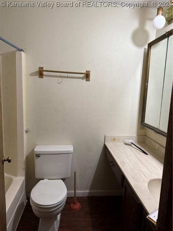 full bathroom featuring hardwood / wood-style floors, vanity, shower / bathtub combination, and toilet