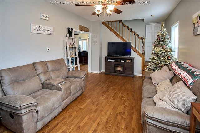 living room featuring hardwood / wood-style flooring, ceiling fan, and a fireplace