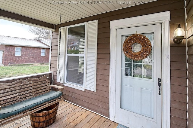 view of exterior entry with covered porch