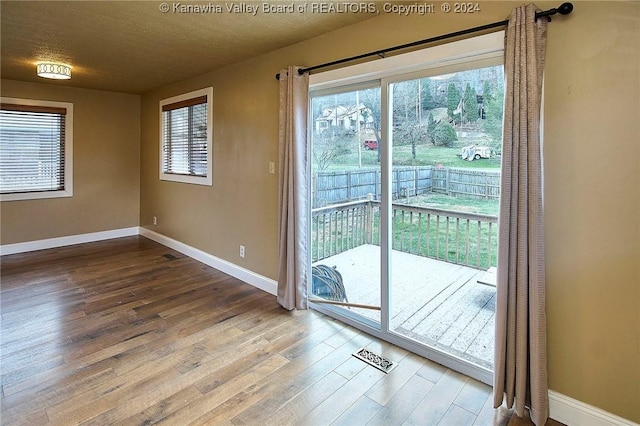 doorway featuring a textured ceiling and hardwood / wood-style flooring