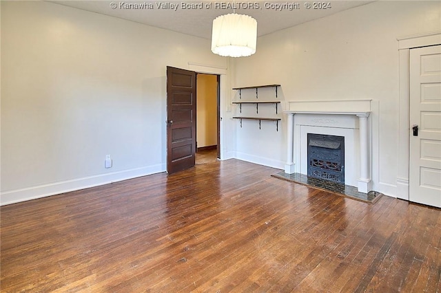 unfurnished living room featuring dark hardwood / wood-style flooring