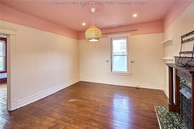 unfurnished dining area featuring dark hardwood / wood-style flooring