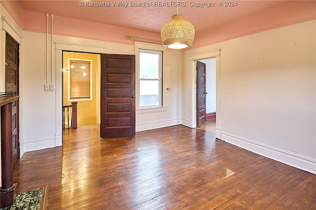 unfurnished room with dark hardwood / wood-style flooring