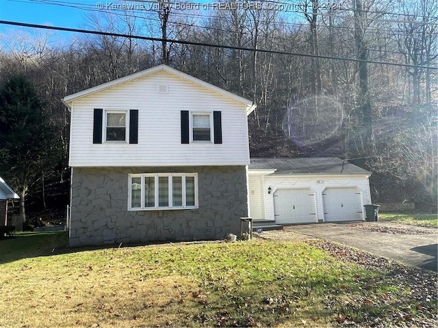 view of front property with a front yard and a garage