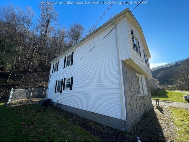 view of side of home featuring central AC unit