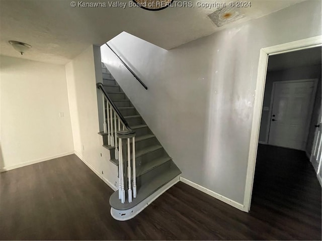 stairway with hardwood / wood-style floors