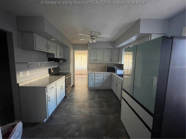 kitchen featuring ceiling fan, black electric range oven, white cabinetry, and fridge