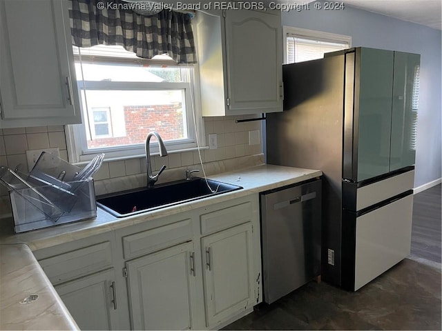 kitchen featuring white cabinetry, sink, appliances with stainless steel finishes, and tasteful backsplash