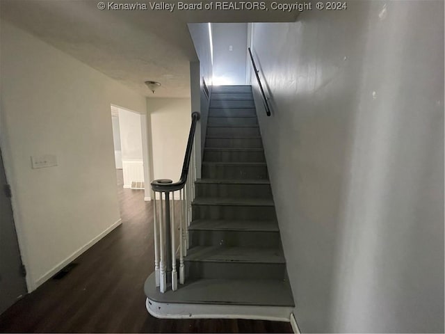 staircase with wood-type flooring