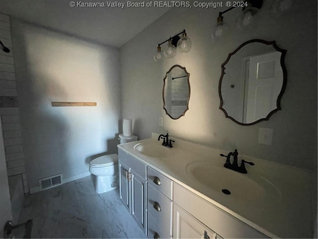 bathroom featuring vanity and toilet