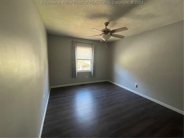 unfurnished room featuring ceiling fan and dark hardwood / wood-style flooring