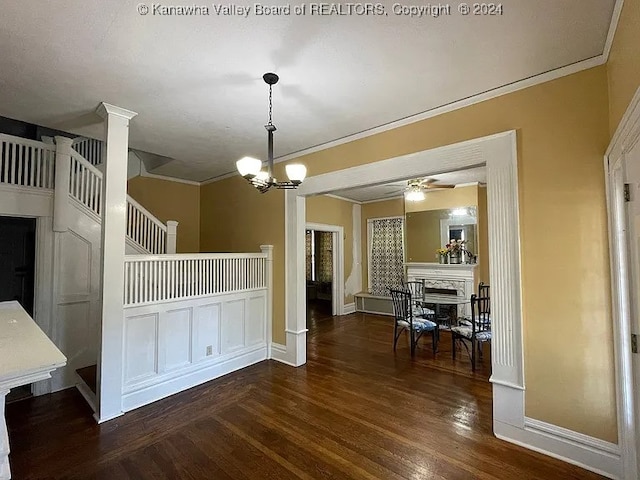 kitchen with a notable chandelier, dark hardwood / wood-style floors, pendant lighting, and ornamental molding