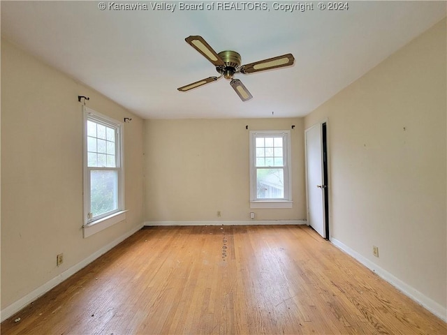 spare room featuring ceiling fan and light wood-type flooring