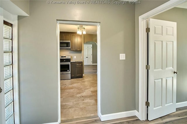 corridor with light hardwood / wood-style floors