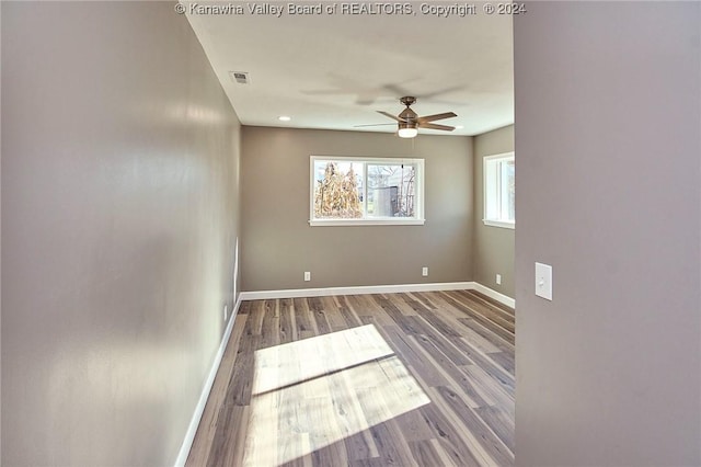 spare room featuring ceiling fan and hardwood / wood-style flooring