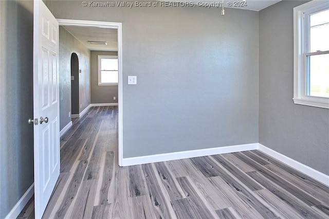 unfurnished room with wood-type flooring