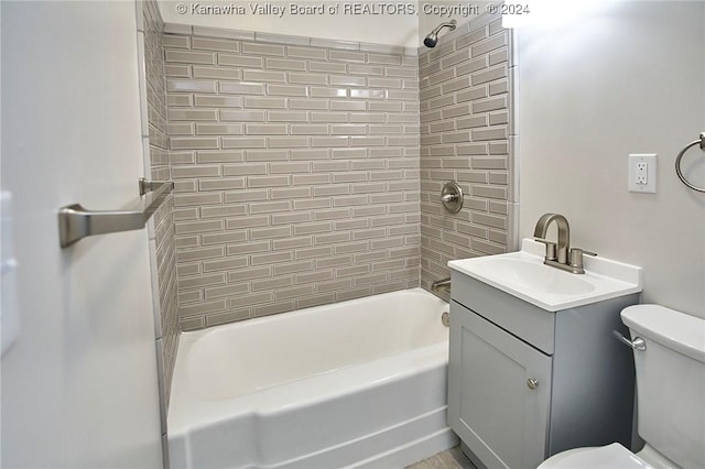 full bathroom with vanity, toilet, and tiled shower / bath combo