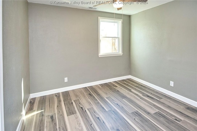 unfurnished room with hardwood / wood-style floors and ceiling fan