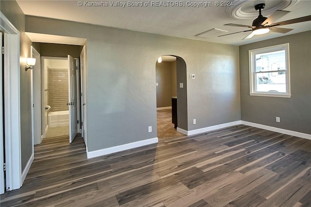 empty room with ceiling fan and dark wood-type flooring