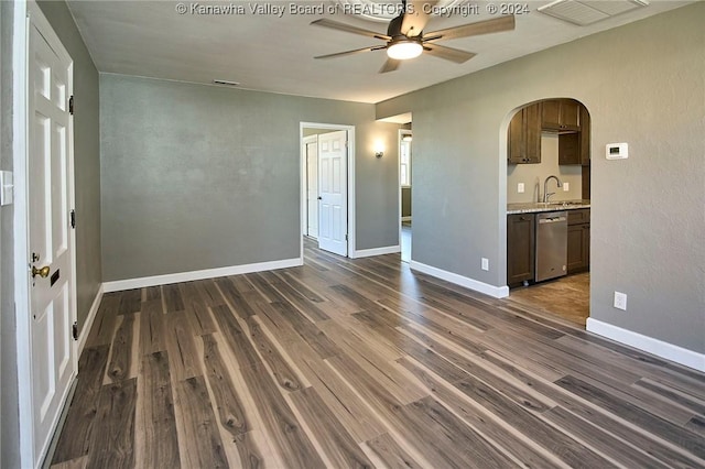 unfurnished room with dark hardwood / wood-style floors, ceiling fan, and sink