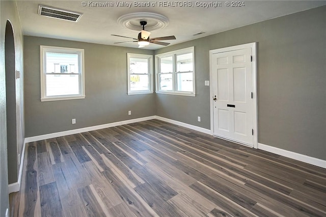 spare room with ceiling fan and dark wood-type flooring