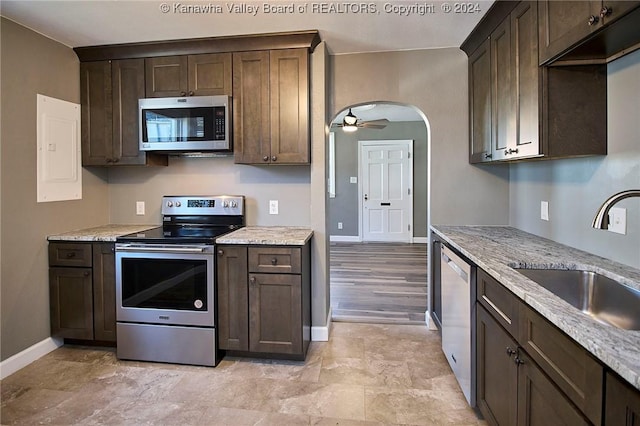 kitchen featuring dark brown cabinetry, ceiling fan, sink, and stainless steel appliances