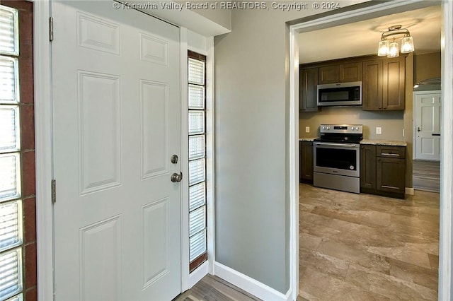 foyer entrance with a chandelier