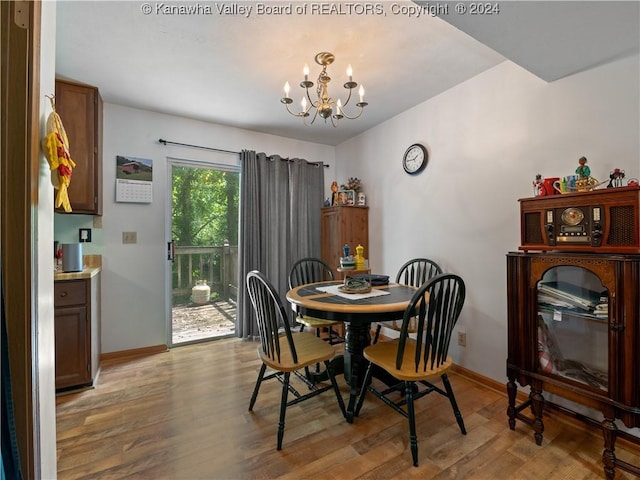 dining room with a chandelier and light hardwood / wood-style floors