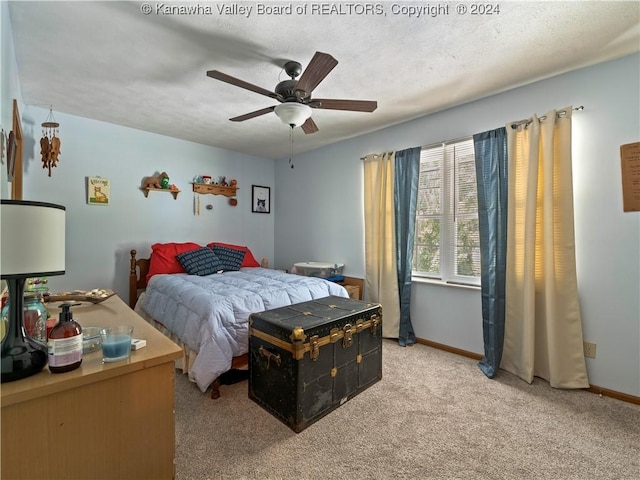 carpeted bedroom featuring a textured ceiling and ceiling fan