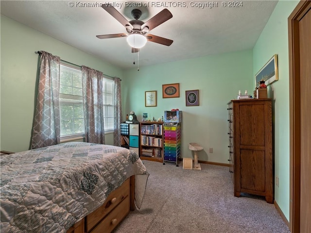 bedroom with light carpet and ceiling fan