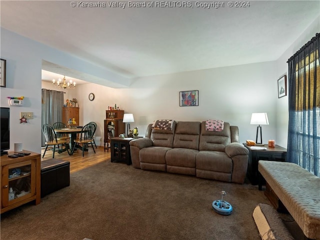 living room with a chandelier and dark wood-type flooring