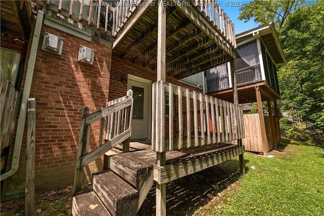 view of exterior entry featuring a lawn