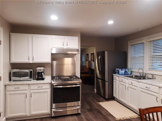 kitchen with dark wood-type flooring, white cabinetry, sink, and stainless steel appliances