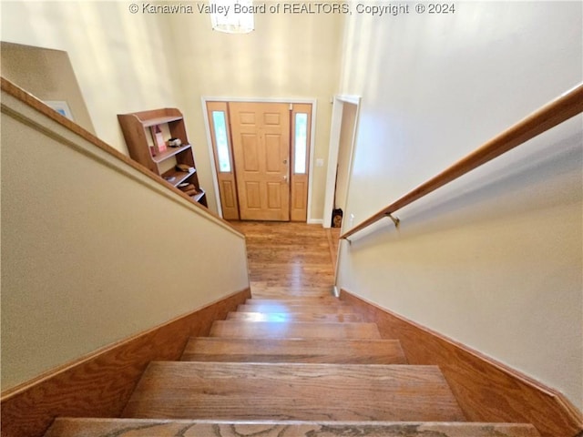 staircase featuring hardwood / wood-style flooring