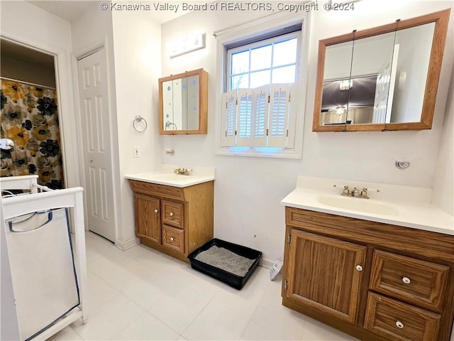 bathroom featuring tile patterned flooring and vanity