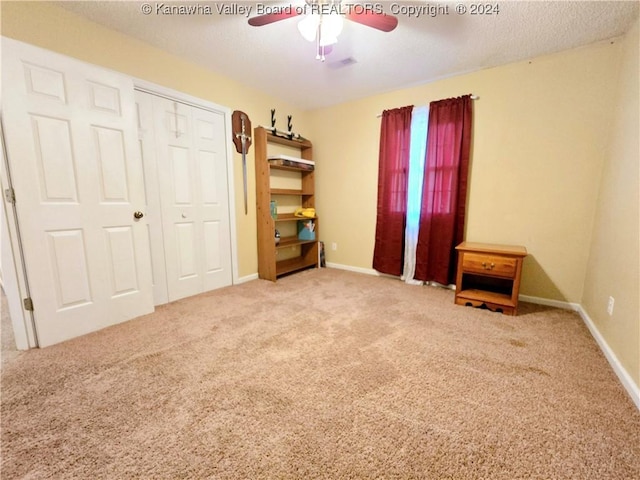 unfurnished bedroom with ceiling fan, carpet floors, and a closet