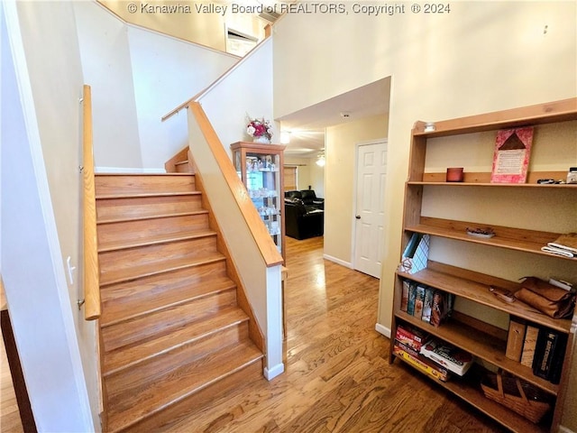 staircase featuring hardwood / wood-style flooring and ceiling fan