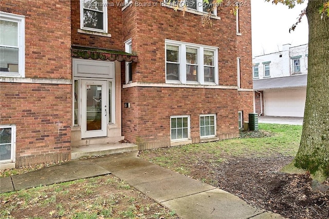 view of exterior entry with brick siding