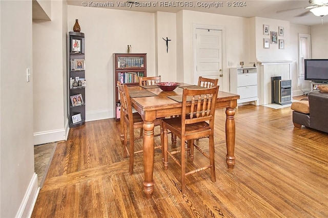 dining space with ceiling fan, baseboards, and wood finished floors