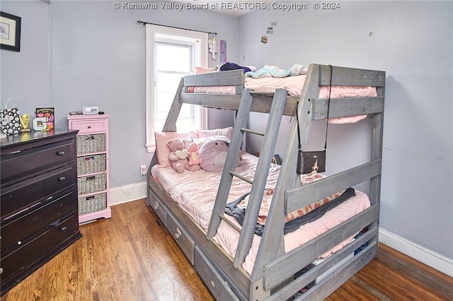 bedroom with baseboards and wood finished floors