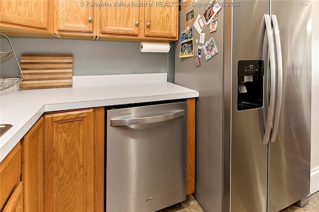 kitchen featuring light countertops, brown cabinets, and stainless steel appliances